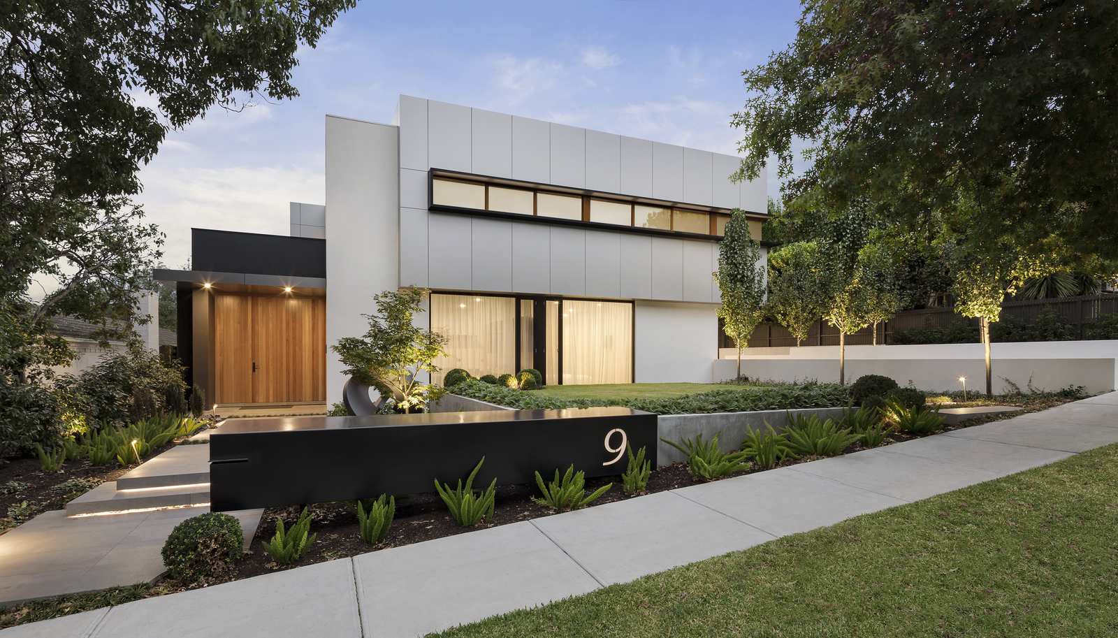 Modern home facade with landscaping designed to echo its architectural lines