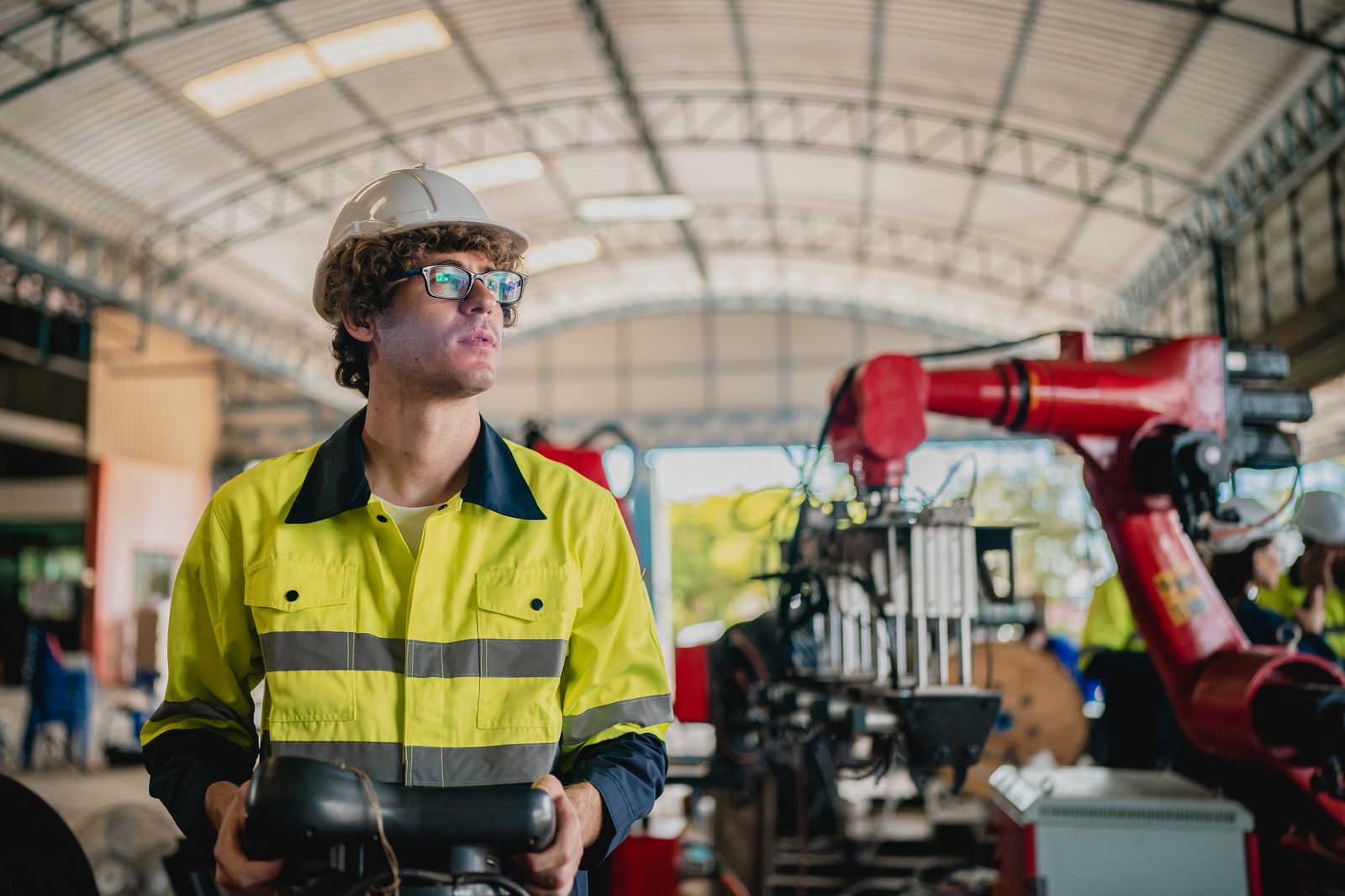 Landscaping worker overseeing an automated machine at a work site