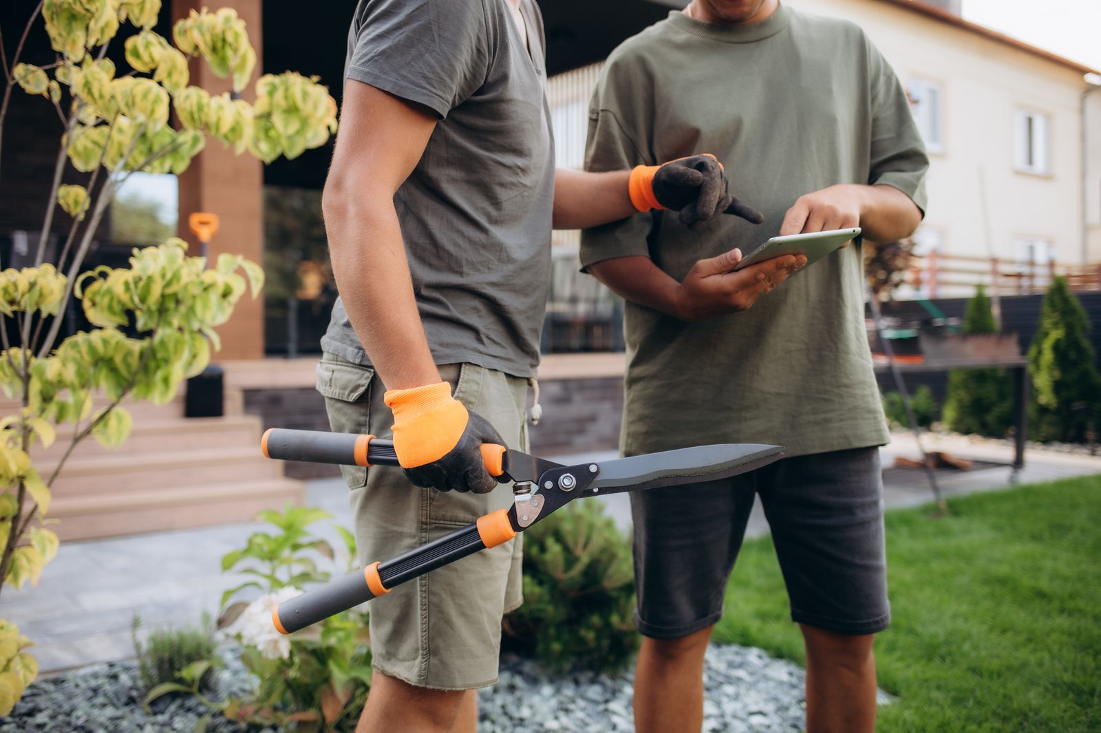 Landscaping trainee learning to operate equipment with guidance from a tablet checklist