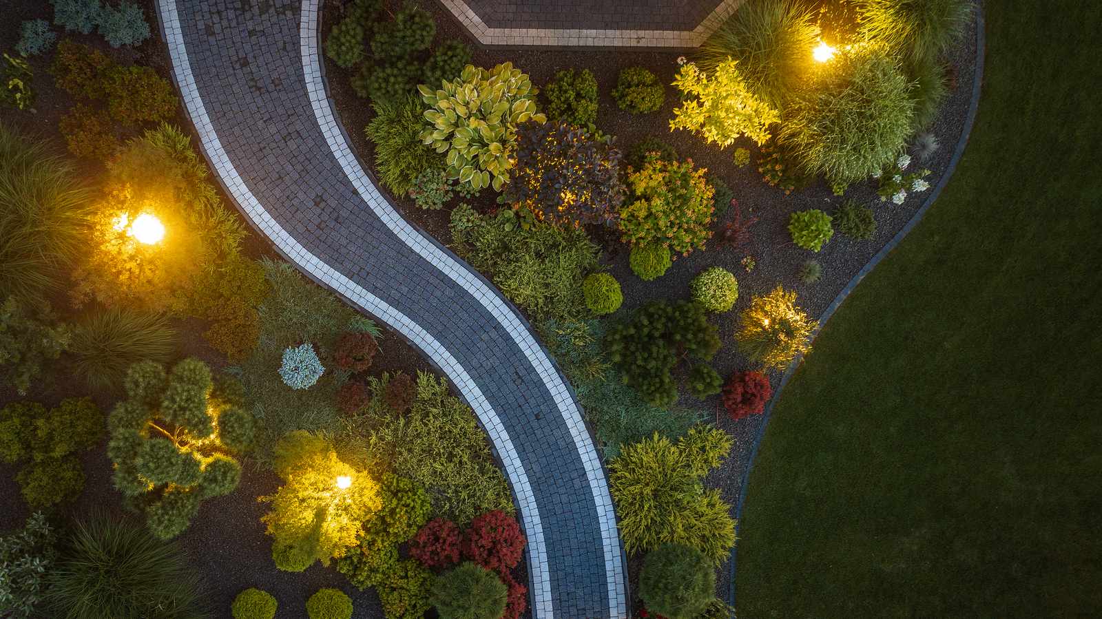 Garden path illuminated by warm outdoor LED lighting at night