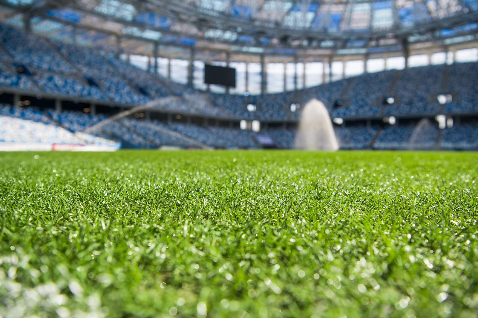 Automated irrigation running on a stadium sports field turf